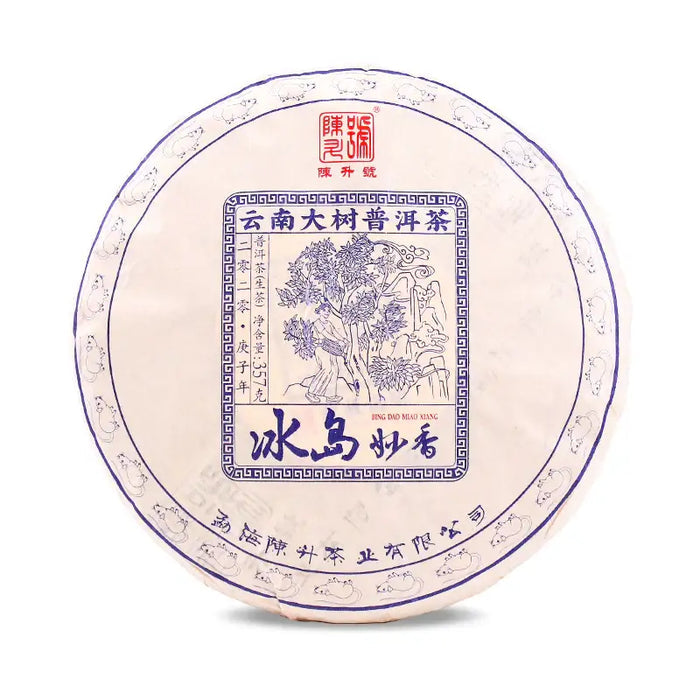 Chinese puerh tea cake wrapped in decorative paper with blue illustration and Chinese characters