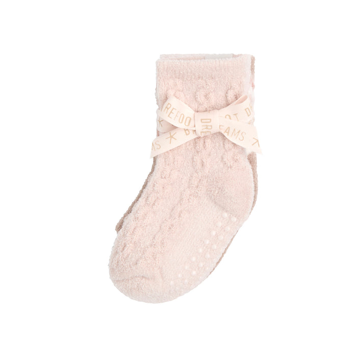 Baby sock folded and tied with a ribbon bow