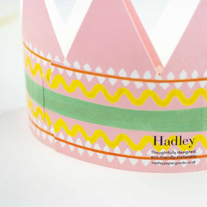 Pink paper crown with colorful patterns and 'Hadley' branding on a white background