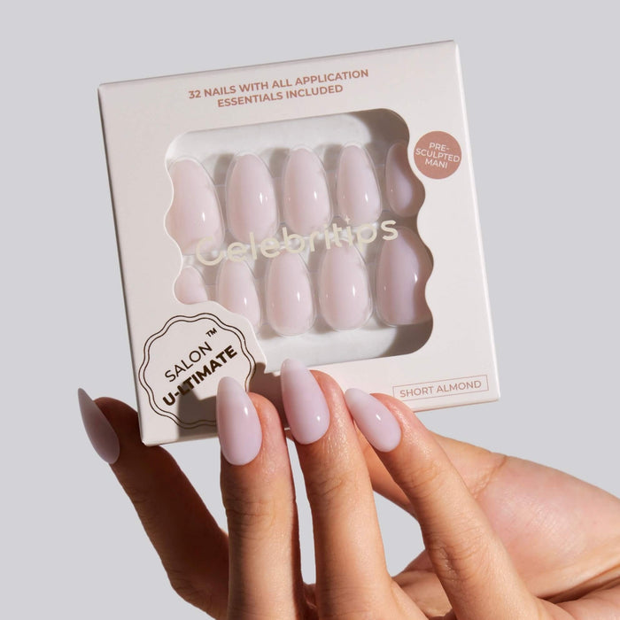 Woman holding Celebritips Ballerina Short Almond press-on nails with packaging displayed