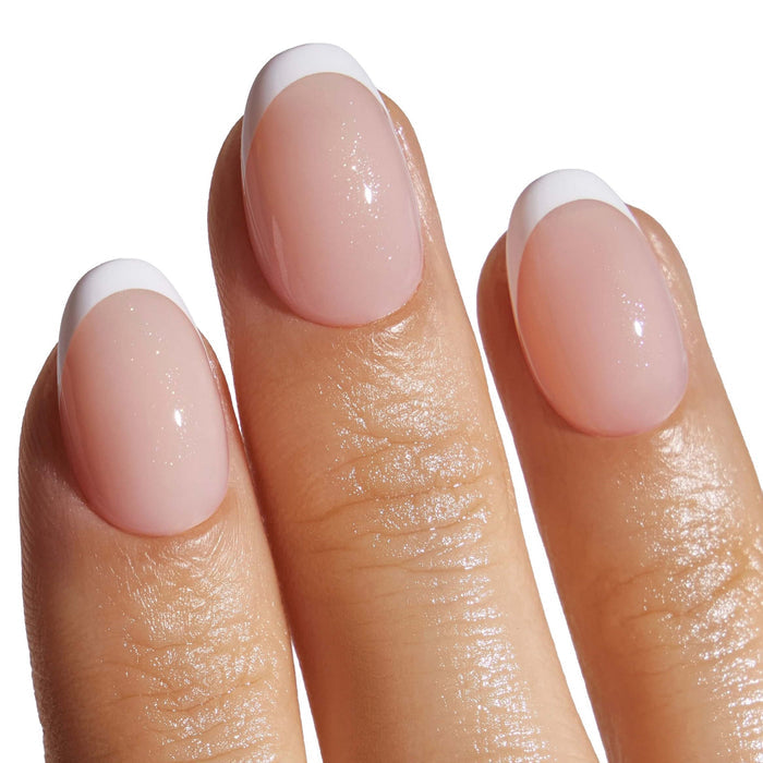 French manicure press-on nails with white tips on model's fingertips, showcasing classic salon look
