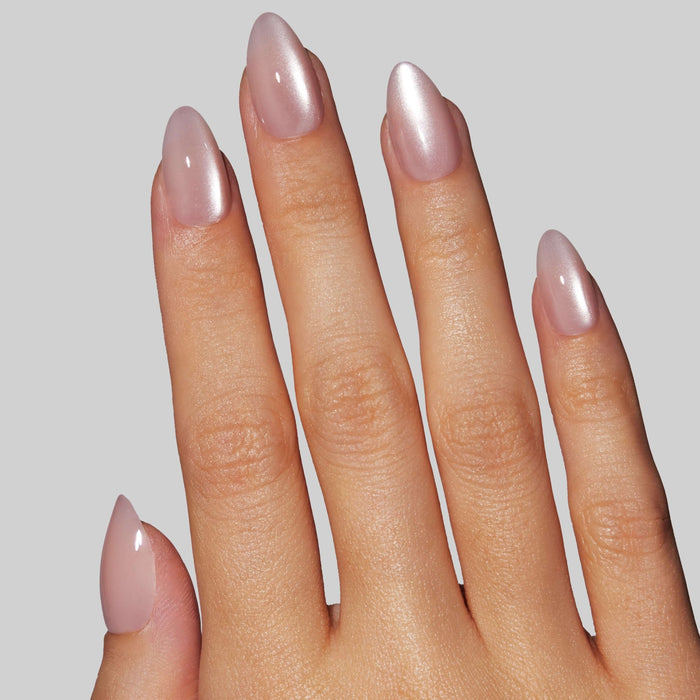Mauve shimmer press-on nails with almond shape worn on hand against neutral background