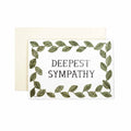 Greeting card with text “deepest sympathy” framed by a green leafy border, shown with a cream envelope.