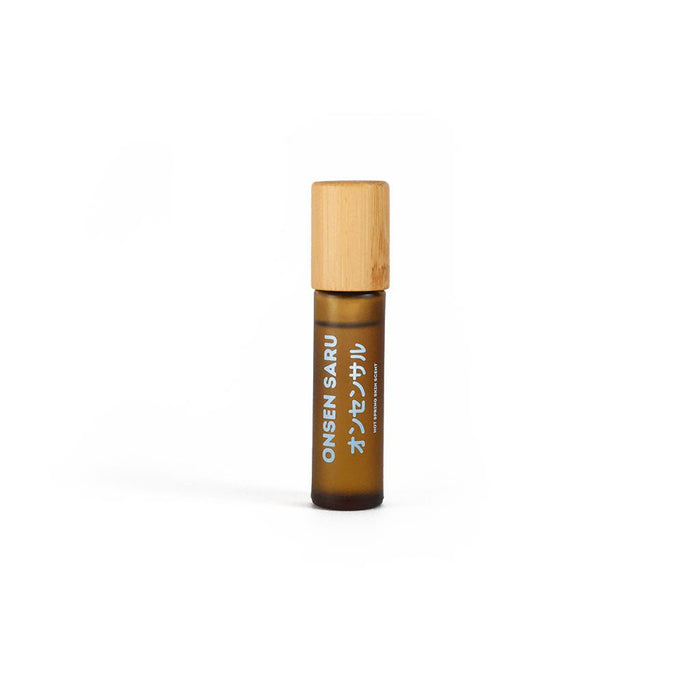Brown roller bottle with wooden cap on a white background