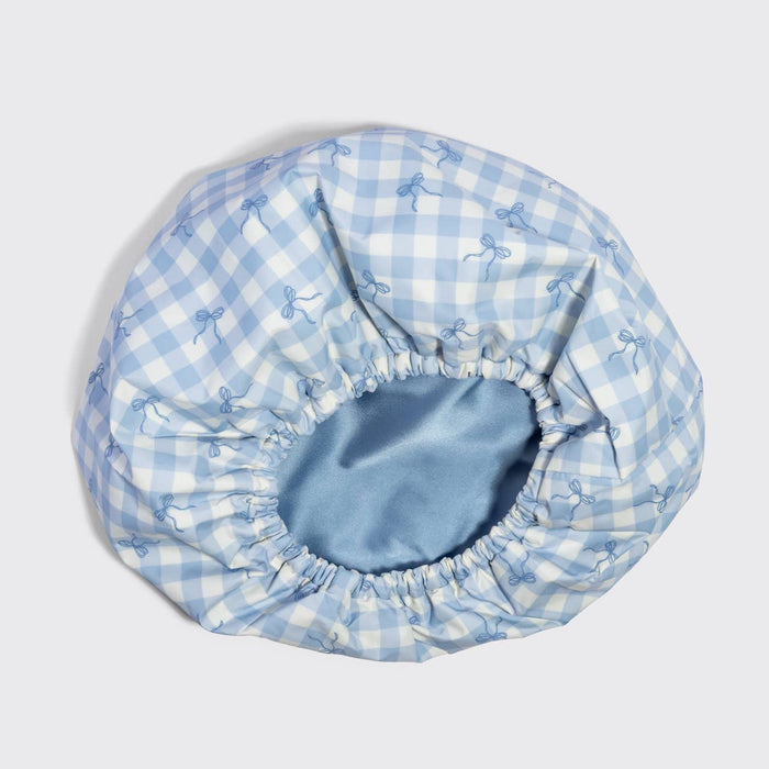 Kitsch satin-lined flexi shower cap in blue gingham pattern with elastic edges
