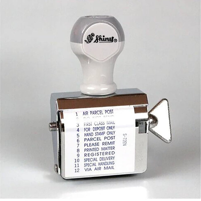 A rotating handheld stamp showing the following phrases: 
1.	AIR PARCEL POST
2.	DO NOT BEND
3.	FIRST CLASS MAIL
4.	FOR DEPOSIT ONLY
5.	HAND STAMP ONLY
6.	PARCEL POST
7.	PLEASE REMIT
8.	PRINTED MATTER
9.	REGISTERED
10.	SPECIAL DELIVERY
11.	SPECIAL HANDLING
12.	VIA AIR MAIL